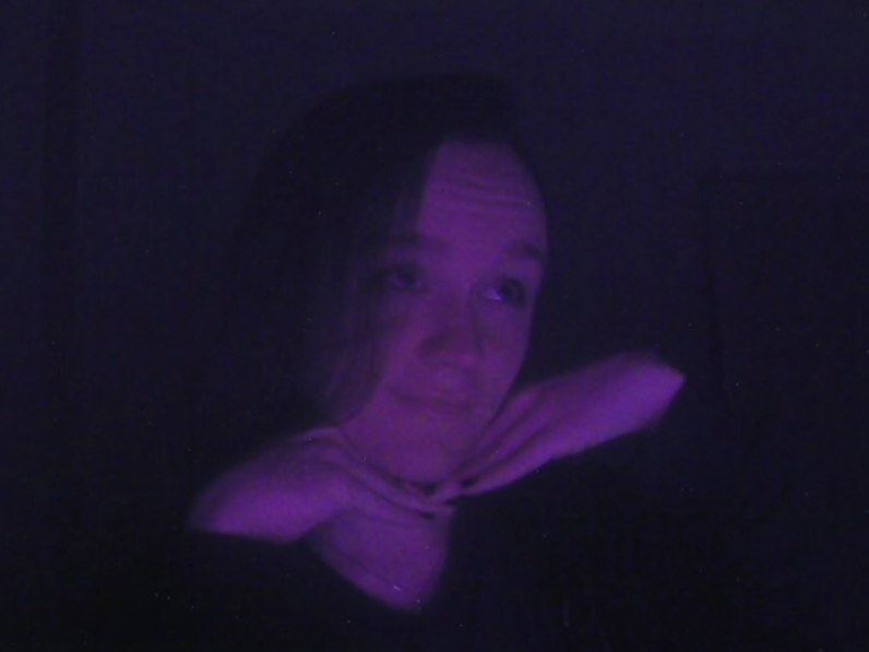 Riona under purple lighting